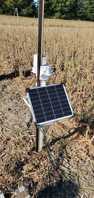 A solar-powered data logger installed in a field